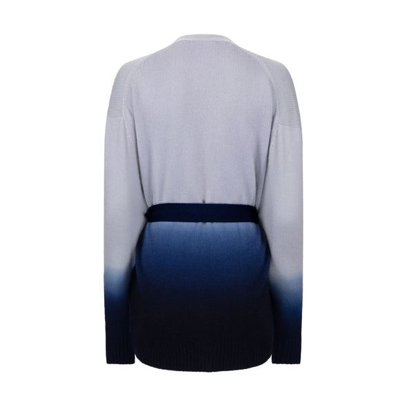Showing back of cashmere cardigan, loosely belted in shades of light to inky blue by Thread Tales