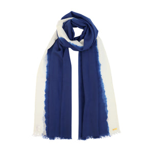 Model wearing floating blue sustainable wool scarf with white soft blurred edge from Thread Tales