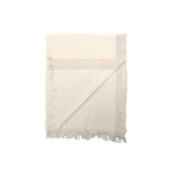 Folded corner detail of elegant Eri silk scarf with subtle edge stripes in neutral tones