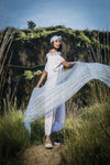 Model with swirling scarf in sustainable linen showing striped blue scarf from Thread Tales