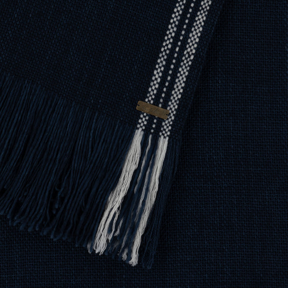 Edge detail of Merino cruelty free indigo blanket wrap  with contrasting cream stripe edging
