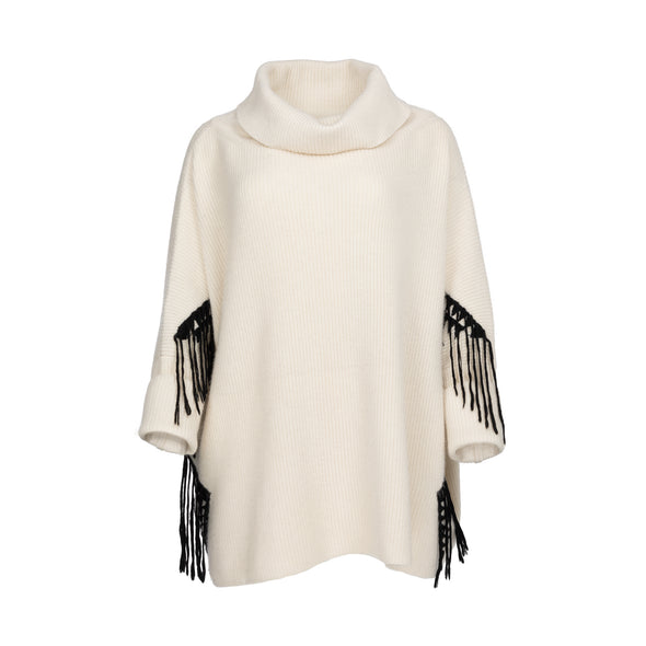 Front view of one size poncho loose-fitting wrap with sleeves knitted in cream 50% cashmere/wool mix edged with a hand-embroidered geometric design in charcoal grey black with trailing threads along edge of body and sleeves from Thread Tales company