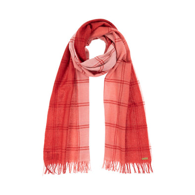Model wearing scarf blush pink woven with subtle open check in darker shade then dip dyed in shades of red to subtle effect. Made from wool and cashmere lightweight warm luxurious scarf from Thread Tales company 