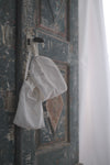 Ivory Lotus silk eye mask and pouch hanging on vintage bedroom cupboard door
