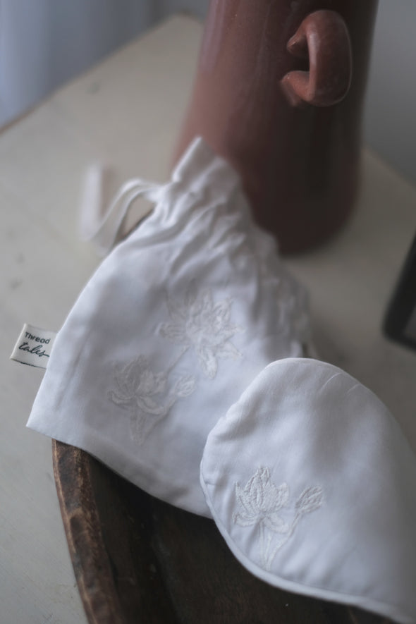 Ivory silk eye mask and pouch embroidered with ivory lotus flower