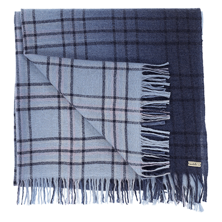 Folded detail of blue scarf woven with subtle open check in darker shade then dip dyed in shades of blue to subtle effect. Made from wool and cashmere lightweight warm luxurious scarf from Thread Tales company 