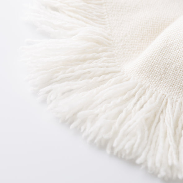Luxurious cream deep fringe of this 100% cruelty free Merino wool blanket