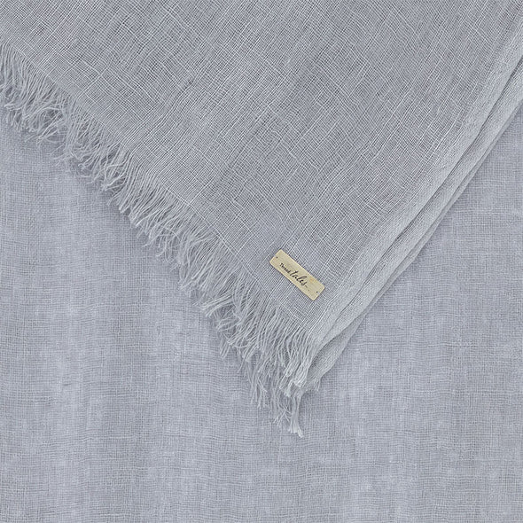Folded corner detail of grey linen scarf. Handwoven and sustainably made from eco dyes by Thread Tales