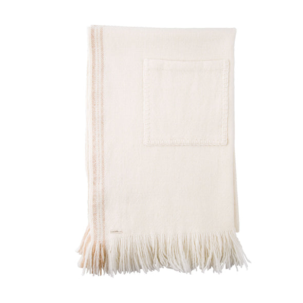 Folded section of cream Merino wool blanket with patch pocket detail, luxurious fringe and side contrast detail