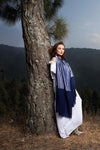 Model wearing long scarf in navy soft cashmere mix with metallic lighter navy blue yarn from Thread Tales company 