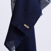 Hanging detail of scarf in navy soft cashmere mix with metallic lighter navy blue yarn from Thread Tales company 